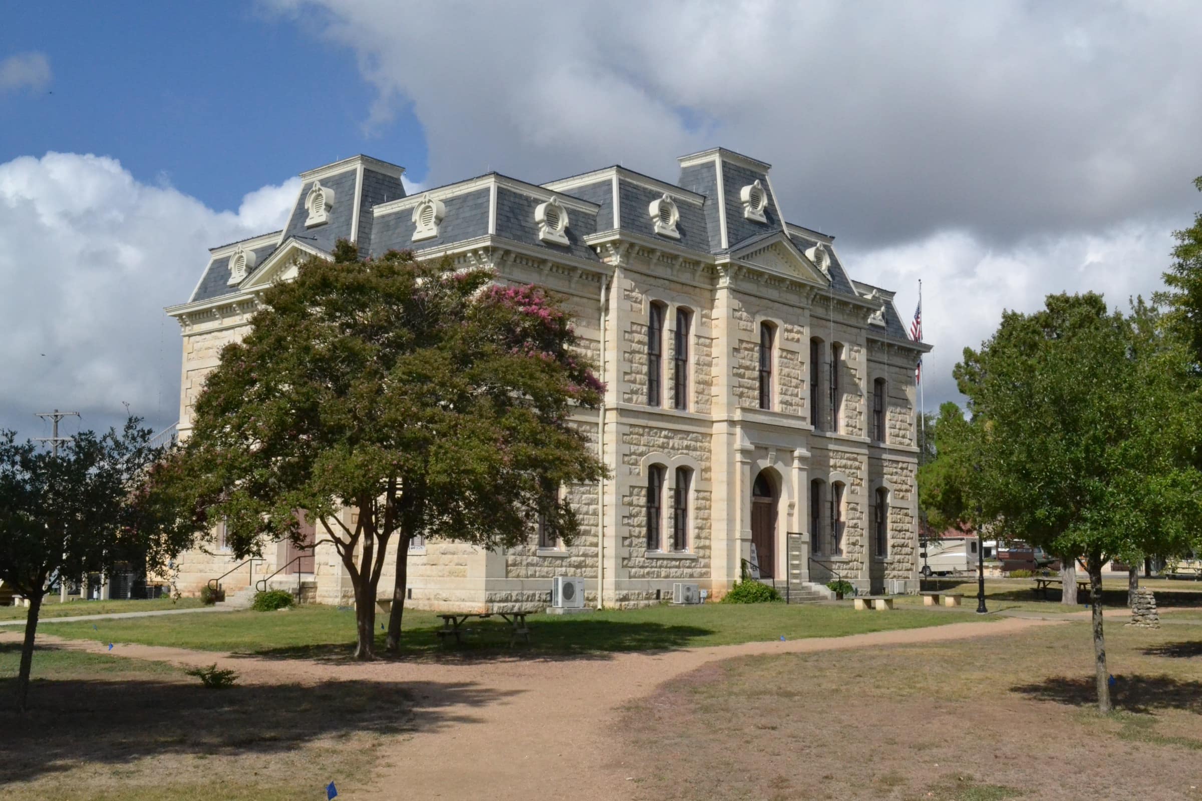The 1886 Second Empire limestone Old Blanco County Courthouse on Main Street under a blue sky