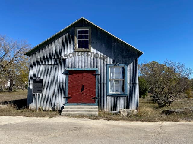 The Fischer Store, a corrugated-tin mercantile with red double doors, in Fischer, Texas